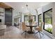 Bright dining area with a decorative light, a round table, and views of the outdoor pool at 20 Twelve Oaks Trl, Ormond Beach, FL 32174