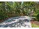 Long paved driveway leads to the home, with a wooden fence and lush landscaping at 20 Twelve Oaks Trl, Ormond Beach, FL 32174