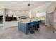 Bright kitchen featuring a large island with seating, white cabinetry, and modern appliances at 20 Twelve Oaks Trl, Ormond Beach, FL 32174