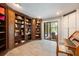 Home library featuring custom bookshelves, desk, and access to the pool area at 20 Twelve Oaks Trl, Ormond Beach, FL 32174