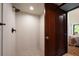 Updated tile shower with rain shower head, handheld wand, and glass door at 20 Twelve Oaks Trl, Ormond Beach, FL 32174
