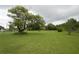 Lush front yard with mature trees, green lawn, and views of the surrounding landscape creating a peaceful environment at 2101 S Goldenrod Rd, Orlando, FL 32822