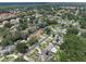 Aerial view of the property highlighting its location in a lush, residential neighborhood, and showing the roof's solar panels at 2122 Palm Crest Dr, Apopka, FL 32712