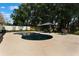 Gorgeous pool, lush landscaping, privacy fence, and outdoor dining create backyard oasis at 2122 Palm Crest Dr, Apopka, FL 32712
