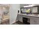 Bathroom with double vanity, granite countertops, and a soaking tub, enhanced by elegant lighting at 2122 Palm Crest Dr, Apopka, FL 32712