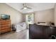 This bedroom features two twin beds, a ceiling fan, and natural light from the window at 2122 Palm Crest Dr, Apopka, FL 32712