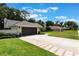 Charming single-story home with a well-manicured front yard, a brick-lined driveway, and a two-car garage at 2122 Palm Crest Dr, Apopka, FL 32712
