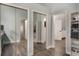 Hallway with mirrored closet, hardwood floors, leading to additional rooms at 2122 Palm Crest Dr, Apopka, FL 32712