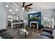 Open concept living room featuring an electric fireplace, modern seating, and seamless flow into the kitchen area at 2122 Palm Crest Dr, Apopka, FL 32712