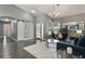 Cozy living room featuring stylish decor, wood-look flooring, a modern light fixture, and plenty of natural light at 2122 Palm Crest Dr, Apopka, FL 32712