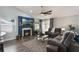 Comfortable living room with an electric fireplace, modern ceiling fan, and plush seating for cozy gatherings at 2122 Palm Crest Dr, Apopka, FL 32712