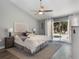 Main bedroom with an ensuite bathroom, a ceiling fan, and sliding glass door access to the backyard pool at 2122 Palm Crest Dr, Apopka, FL 32712