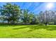 Large grassy backyard with mature trees offering shade at 2538 Carter Grove Cir, Windermere, FL 34786