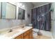 Bathroom with a double vanity, decorative shower curtain, and a toilet at 2538 Carter Grove Cir, Windermere, FL 34786