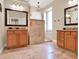 Bathroom featuring dual vanities and a tiled walk-in shower with a decorative chandelier at 2538 Carter Grove Cir, Windermere, FL 34786