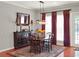 Cozy dining room with a wooden table set with seating, an area rug, and a cabinet with a mirror at 2538 Carter Grove Cir, Windermere, FL 34786