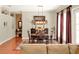 Dining room with a wooden table set with seating, an area rug, and large windows with curtains at 2538 Carter Grove Cir, Windermere, FL 34786