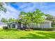 Attractive single-story home with well-maintained lawn and verdant tree at 2538 Carter Grove Cir, Windermere, FL 34786