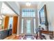 Welcoming foyer features hardwood floors, a stylish console table, and a view into adjacent dining and office areas at 2538 Carter Grove Cir, Windermere, FL 34786