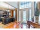 Bright foyer features hardwood floors, a decorative front door, and a view of the office at 2538 Carter Grove Cir, Windermere, FL 34786
