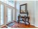 Welcoming foyer with hardwood floors, elegant console table, and a decorative mirror for a stylish entry at 2538 Carter Grove Cir, Windermere, FL 34786