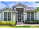 Welcoming front entrance with decorative glass door, sidelights and manicured landscaping at 2538 Carter Grove Cir, Windermere, FL 34786