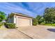 Spacious two-car garage featuring a neutral door and manicured landscaping enhancing curb appeal at 2538 Carter Grove Cir, Windermere, FL 34786