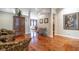 Hallway with hardwood floors, decorative accents, and views into multiple rooms at 2538 Carter Grove Cir, Windermere, FL 34786