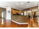 Open kitchen with bar seating, hardwood floors, and access to the laundry room at 2538 Carter Grove Cir, Windermere, FL 34786