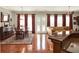 Open-concept living room and dining area with hardwood floors and French doors to the backyard at 2538 Carter Grove Cir, Windermere, FL 34786