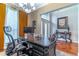 Well-lit office featuring a large desk, comfortable chair, and view of the foyer at 2538 Carter Grove Cir, Windermere, FL 34786