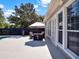 Charming patio with a dining set, views of the pool, and lots of natural light from windows at 2538 Carter Grove Cir, Windermere, FL 34786