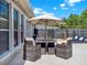 Charming patio area featuring an outdoor dining set and a partial view of a lovely in-ground pool at 2538 Carter Grove Cir, Windermere, FL 34786