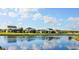 Waterfront view of homes with spacious yards, lush landscaping, and a tranquil atmosphere at 2545 Old Kent Cir, Kissimmee, FL 34758