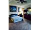Cozy bedroom with neutral carpet, ceiling fan and a large window for natural light at 2545 Old Kent Cir, Kissimmee, FL 34758
