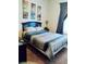 Bedroom features a stylish bed with patterned bedding and soft, neutral-colored walls at 2545 Old Kent Cir, Kissimmee, FL 34758