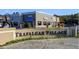 Trafalgar Village entrance with retail shops, offering convenient amenities and a welcoming atmosphere at 2545 Old Kent Cir, Kissimmee, FL 34758