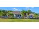 Community pool area with plenty of seating, lush greenery, and a well-maintained lawn at 2545 Old Kent Cir, Kissimmee, FL 34758