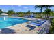 The spacious pool features a unique water feature and is surrounded by lounge chairs at 2545 Old Kent Cir, Kissimmee, FL 34758