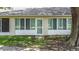 Back exterior with grass and windows with views into the sun room of the home at 2724 Shelby Ruth Pl, St Cloud, FL 34769