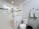 Bright white bathroom with shower, toilet, and gray walls at 2724 Shelby Ruth Pl, St Cloud, FL 34769