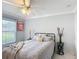Cozy bedroom with a ceiling fan, stylish bed, and a soothing gray color scheme at 2724 Shelby Ruth Pl, St Cloud, FL 34769