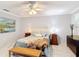 Bright bedroom featuring stylish furnishings, including a faux fur throw, elegant lighting and decorative wall art at 2724 Shelby Ruth Pl, St Cloud, FL 34769