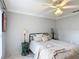 Cozy bedroom with a ceiling fan, stylish bed, and a soothing gray color scheme at 2724 Shelby Ruth Pl, St Cloud, FL 34769