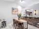 Dining area with a brick accent wall and connection to the modern kitchen at 2724 Shelby Ruth Pl, St Cloud, FL 34769