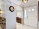 Bright foyer featuring marble floors, a white door, and access to the kitchen with dark wood cabinets at 2724 Shelby Ruth Pl, St Cloud, FL 34769