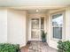 Inviting front porch with decorative plants, a storm door, and tiled flooring leading to the main entrance at 2724 Shelby Ruth Pl, St Cloud, FL 34769