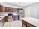 Modern kitchen featuring stainless steel appliances, dark wood cabinets, and quartz countertops for a sleek finish at 2724 Shelby Ruth Pl, St Cloud, FL 34769