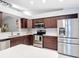 Modern kitchen with stainless steel appliances, custom cabinets, and stylish backsplash at 2724 Shelby Ruth Pl, St Cloud, FL 34769