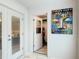 Hallway view showing access to the laundry room with a Buddha painting on the wall at 2724 Shelby Ruth Pl, St Cloud, FL 34769